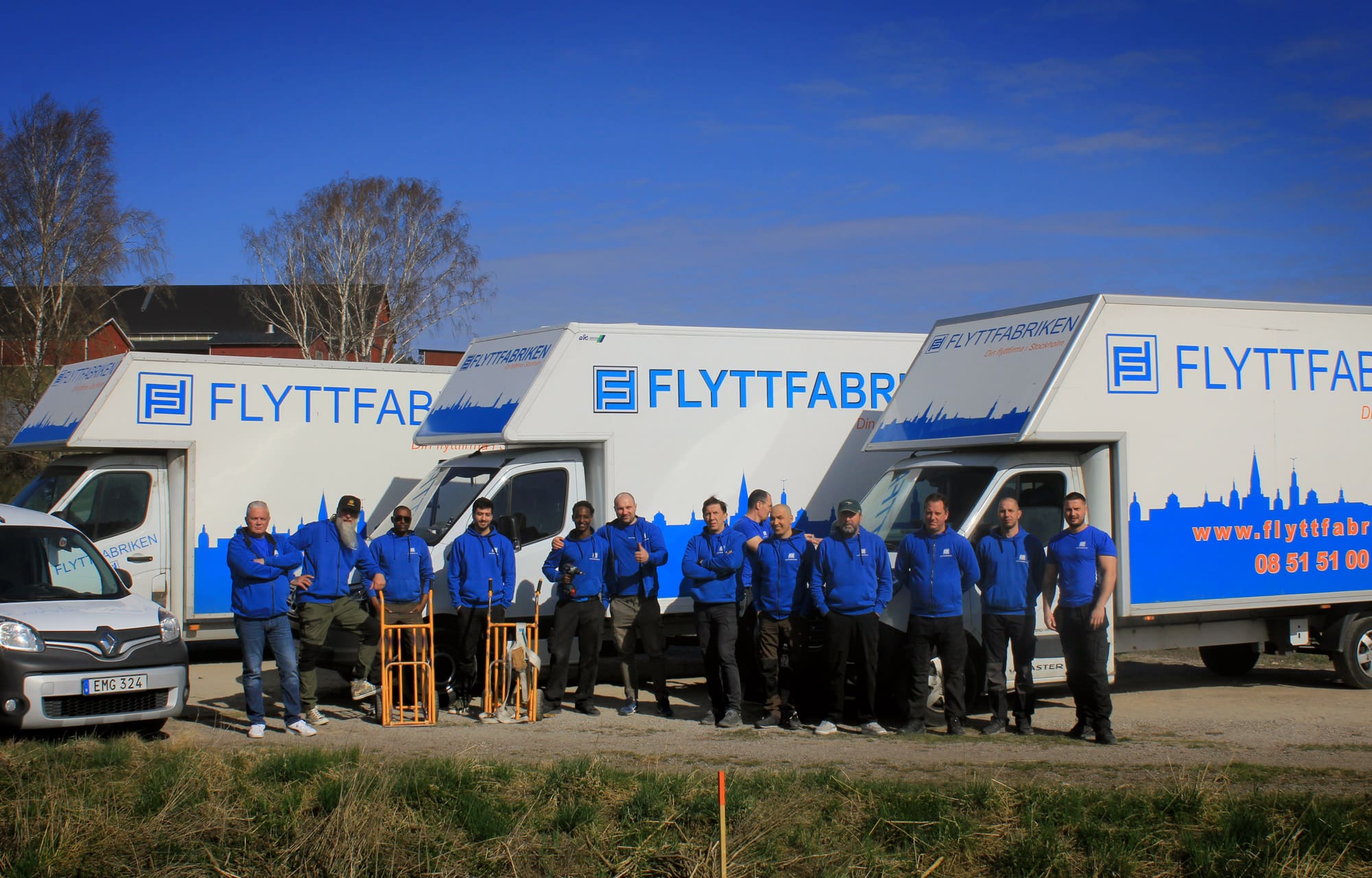 Flyttfabrikens flyttare framför flyttbilen